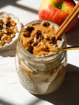 Creamy apple cinnamon overnight oats with shredded apple, cinnamon, and a drizzle of almond butter.