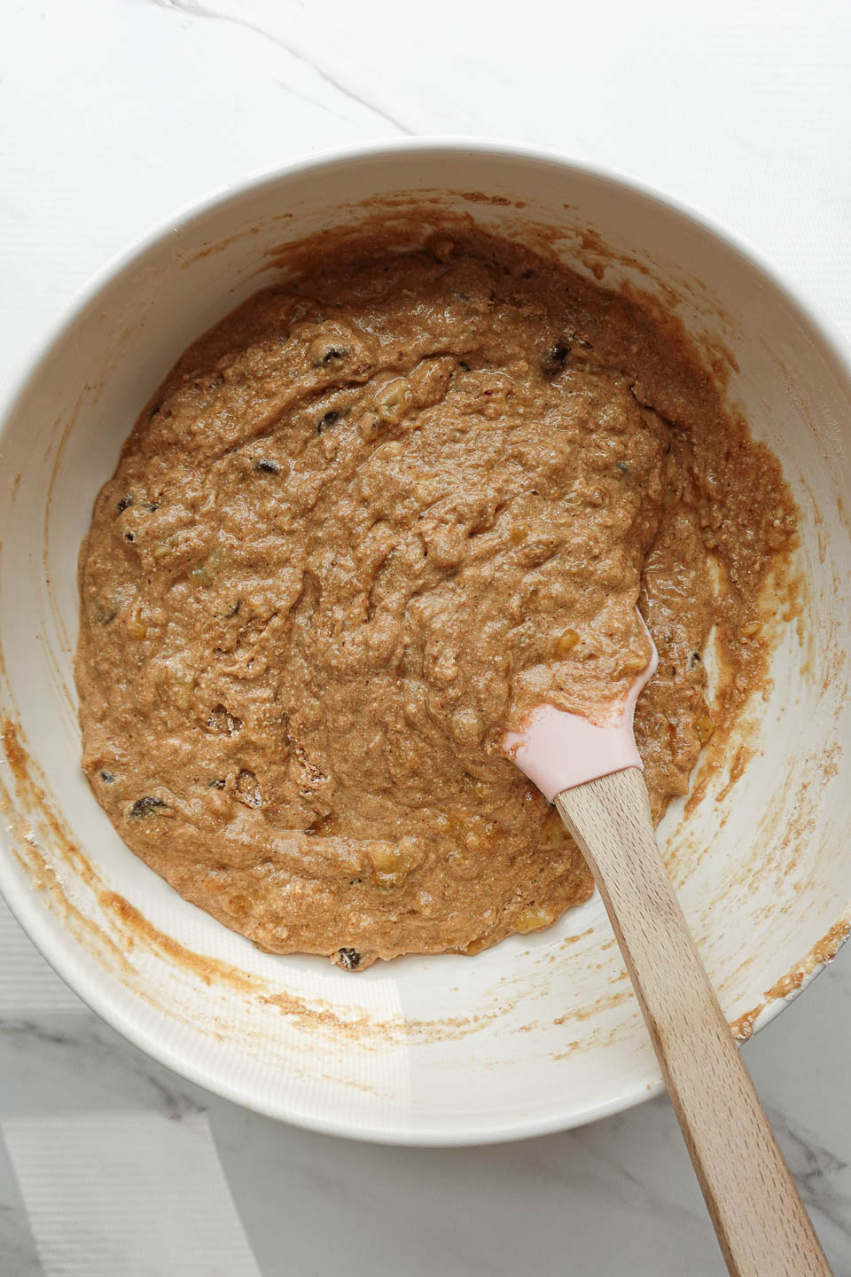 mixing the banana bread batter in a large bowl