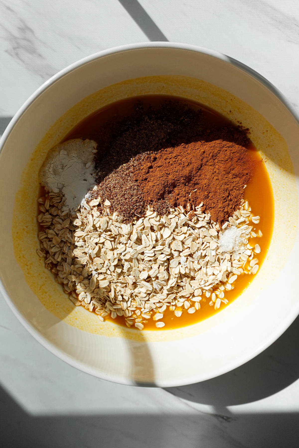 Pumpkin baked oatmeal ingredients in a bowl.