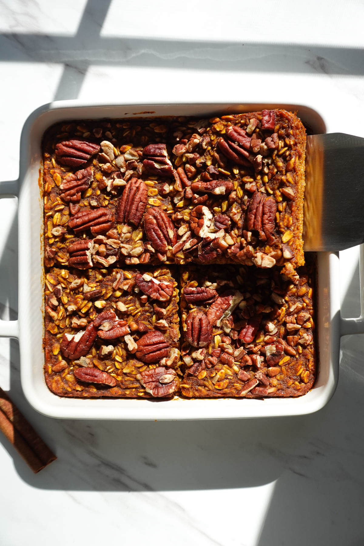 4 slices of pumpkin baked oatmeal in a dish.