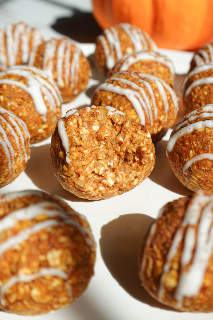 Pumpkin spice energy ball with a bite taken out showing the chewy texture