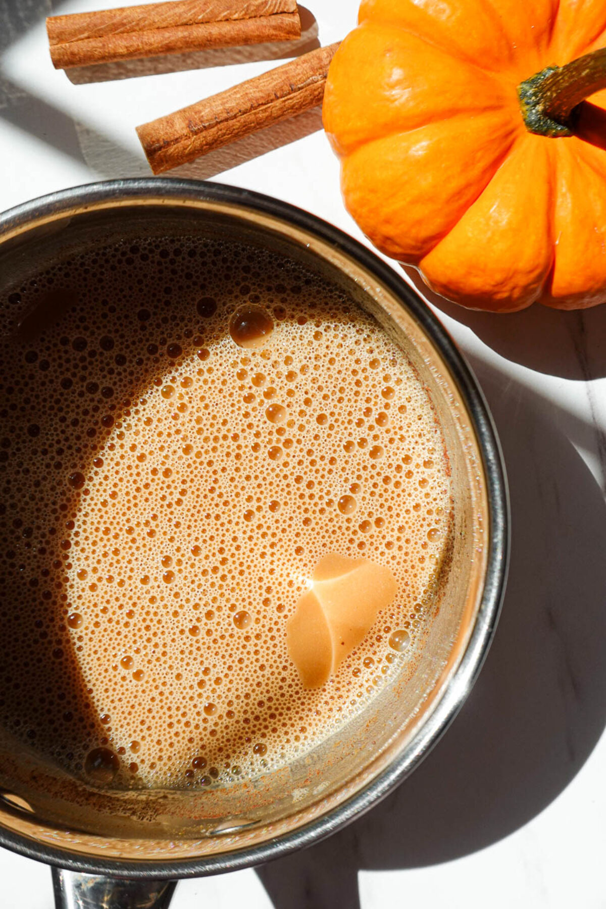 Pumpkin milk mixture steaming in a saucepan