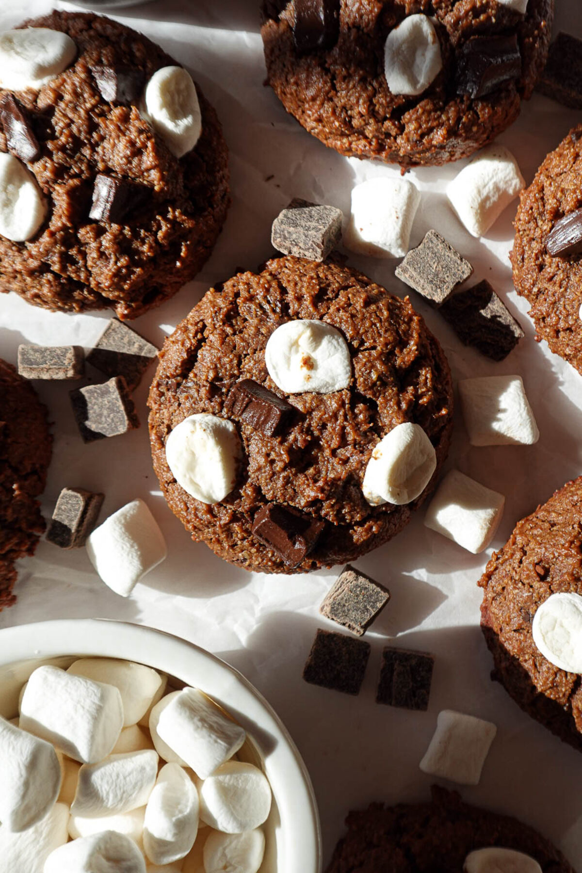 Gluten-free and vegan hot chocolate cookies with chocolate chunks and mini marshmallows, perfect for a festive holiday dessert.