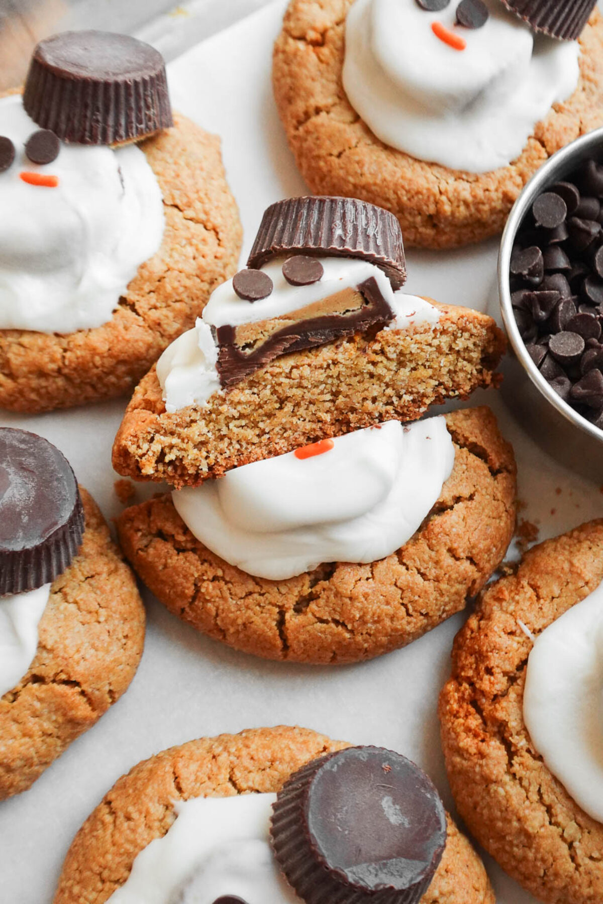 Vegan melted snowman cookie cut in half showing soft and chewy interior of the peanut butter cookie