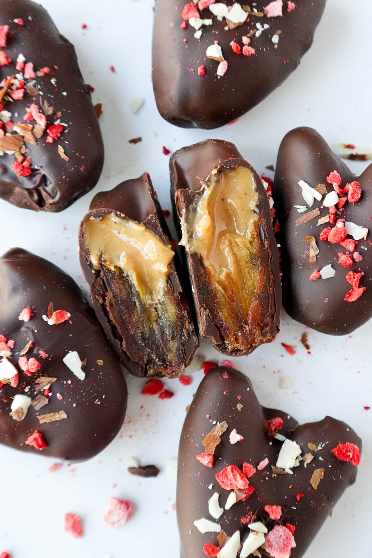 Close up of medjool date cut in half showing the peanut butter filling.