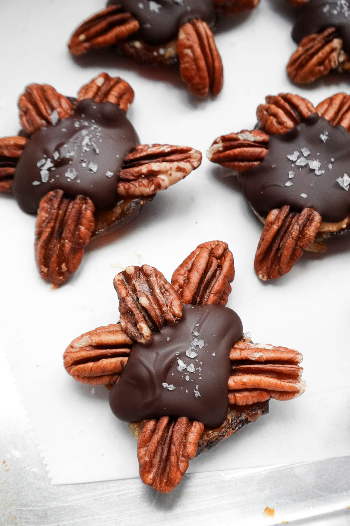 No bake vegan chocolate turtles sprinkled with flaky sea salt, adding a sweet and salty finish.