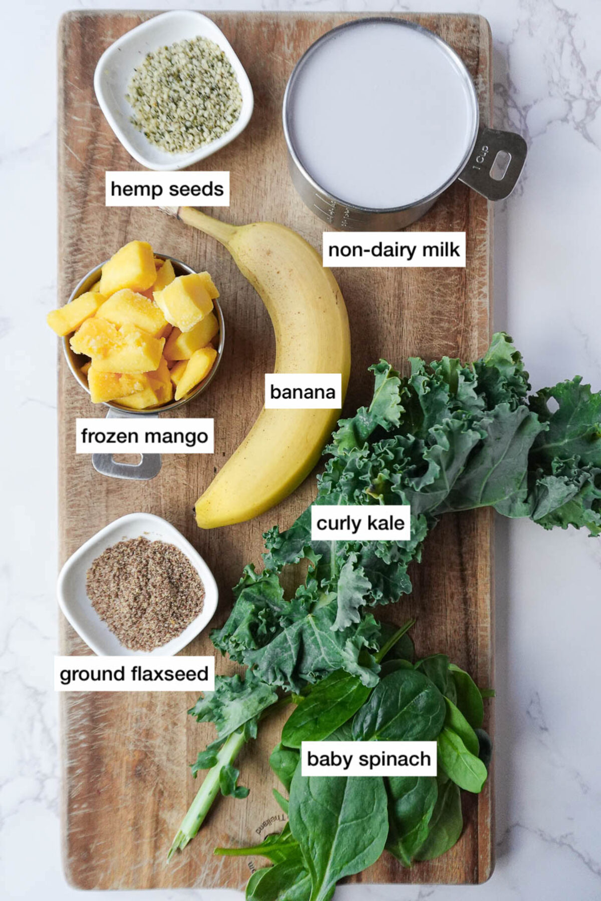 ingredients to make my go-to green smoothie recipe arranged on a cutting board