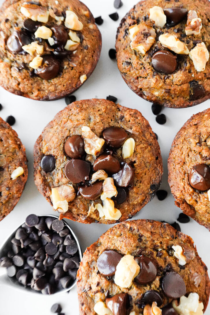 overhead shot of healthy banana muffins topped with chocolate chips and walnuts, vegan, gluten-free and naturally sweetened.