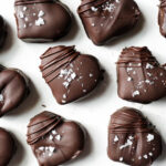 Healthy homemade chocolate caramels shaped like hearts and drizzled with chocolate, perfect for Valentine’s Day.