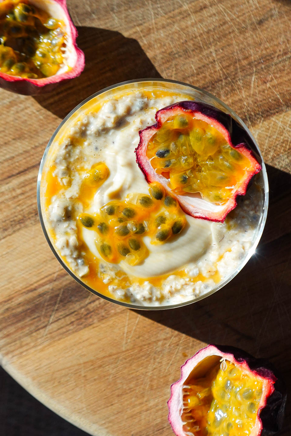 Overhead photo of tropical Mango & Passion Fruit Overnight Oats topped with a halved passionfruit
