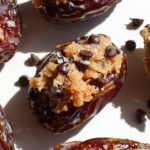 Vegan cookie dough stuffed dates filled with almond flour cookie dough and mini chocolate chips.