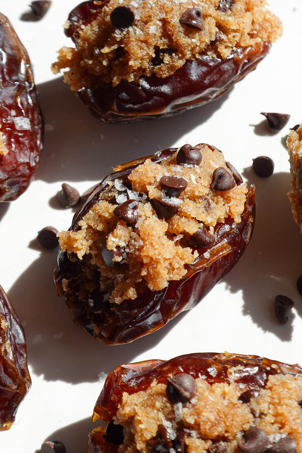 Vegan cookie dough stuffed dates filled with almond flour cookie dough and mini chocolate chips.