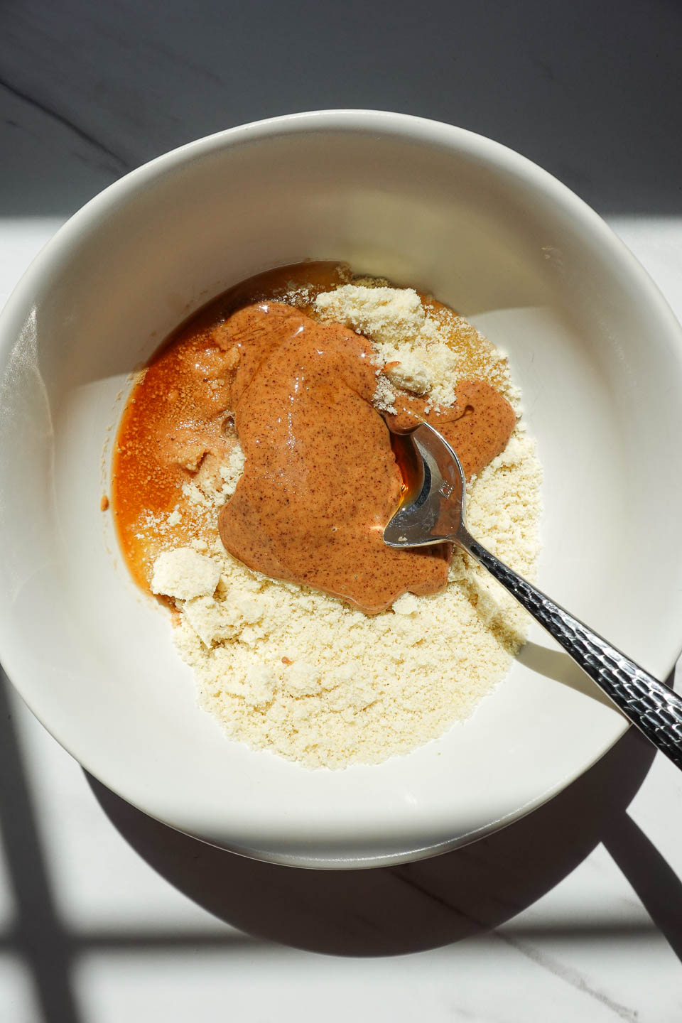 Almond flour, almond butter, maple syrup, vanilla, and in a bowl