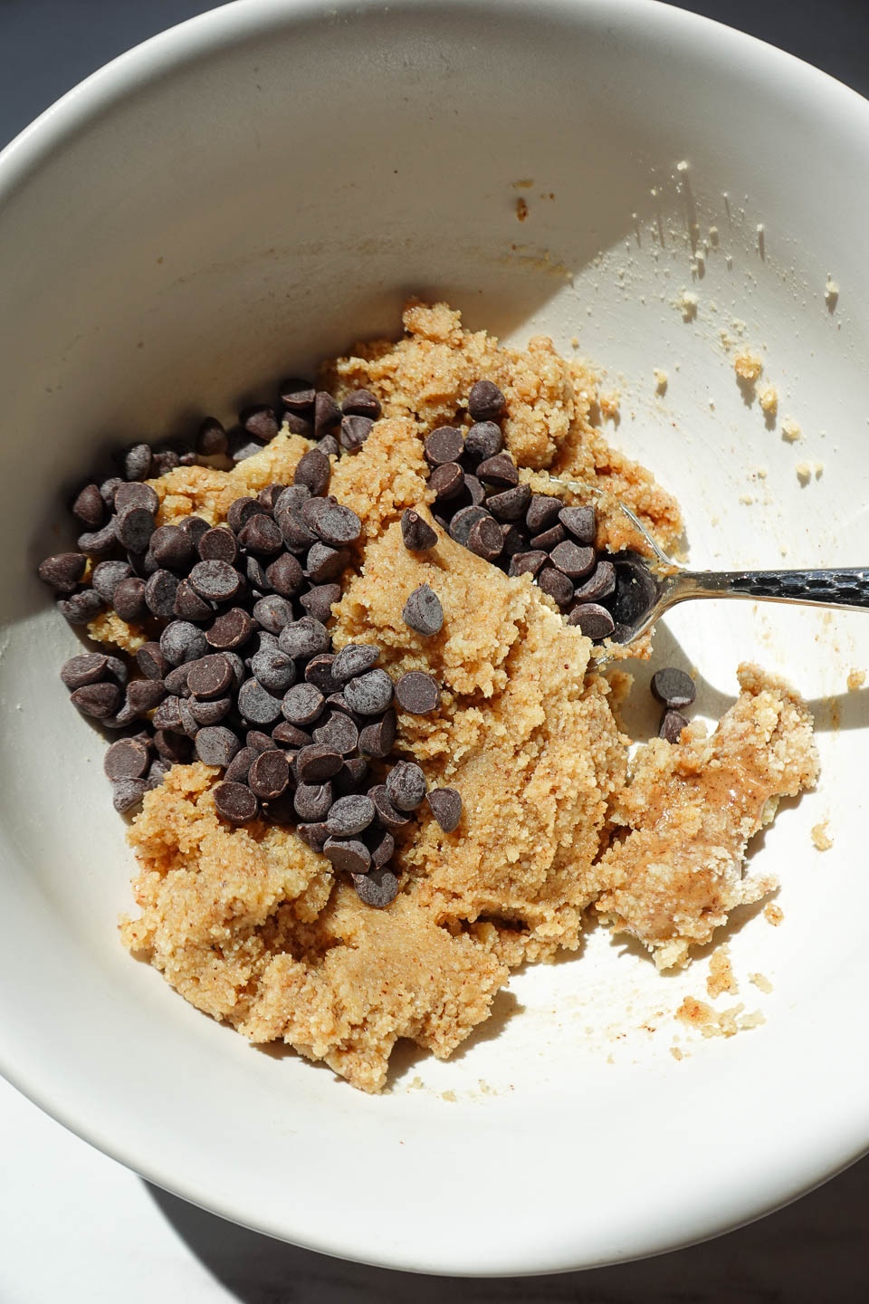 adding mini chocolate chips to edible cookie dough