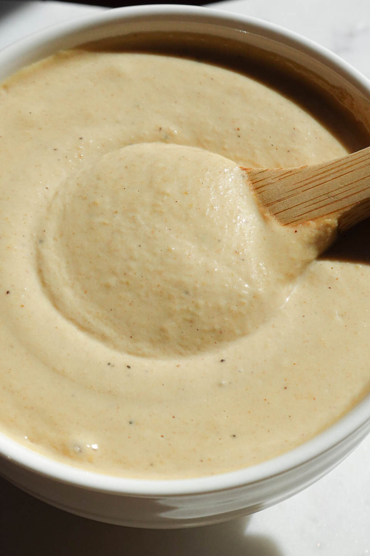 Lemon tahini dressing made with tahini, lemon juice, and nutritional yeast.