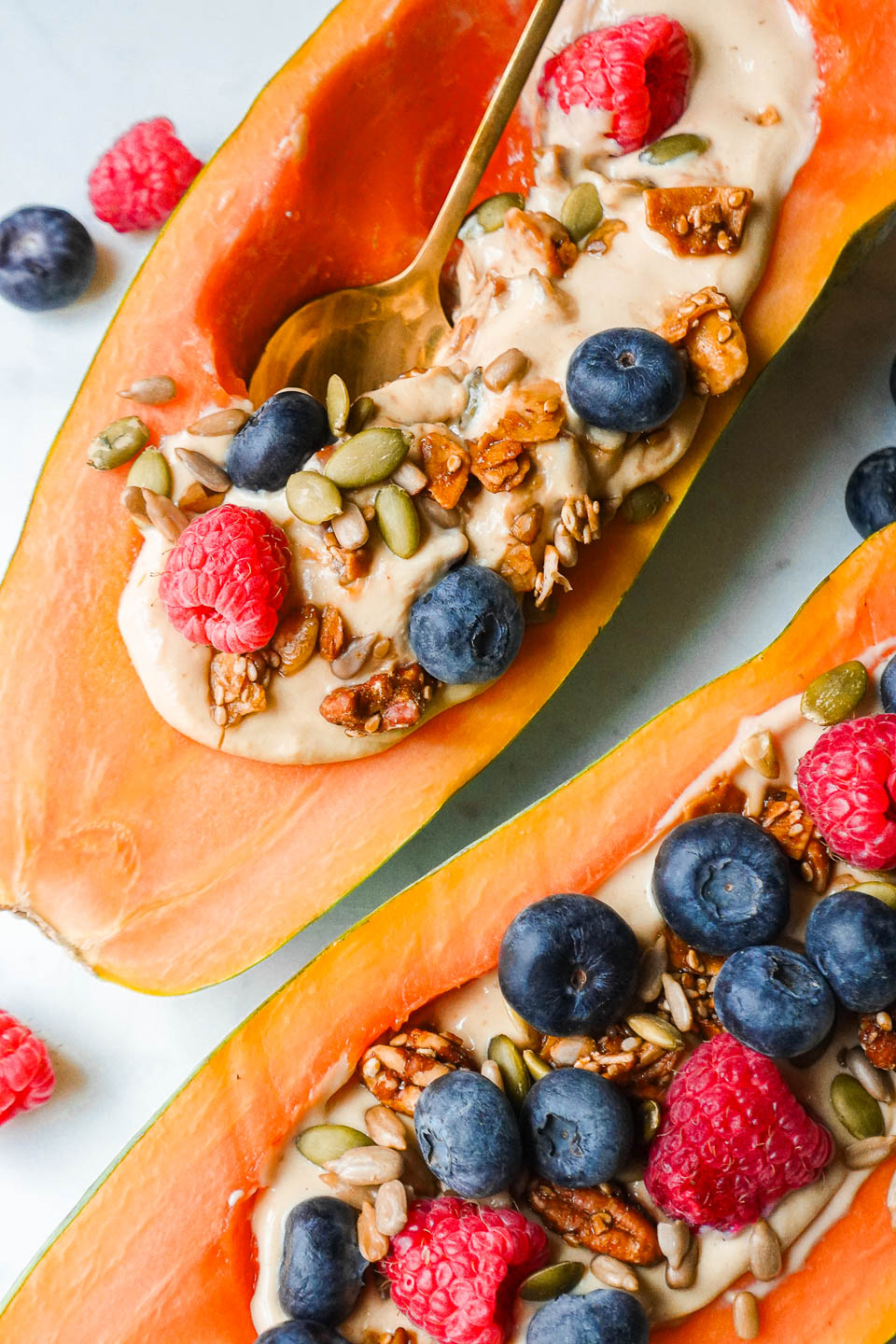 a spoonful of yogurt from a papaya yogurt bowl