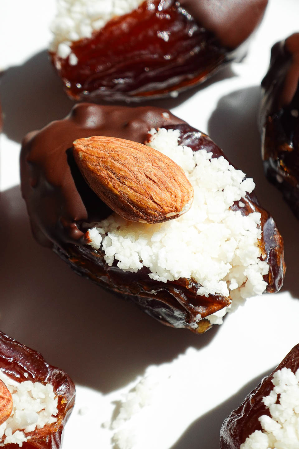 Close-up of chewy medjool dates stuffed with sweet coconut and coated in melted vegan chocolate