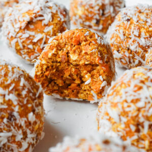 Soft carrot cake energy ball with. bite taken out showing chewy, soft texture inside