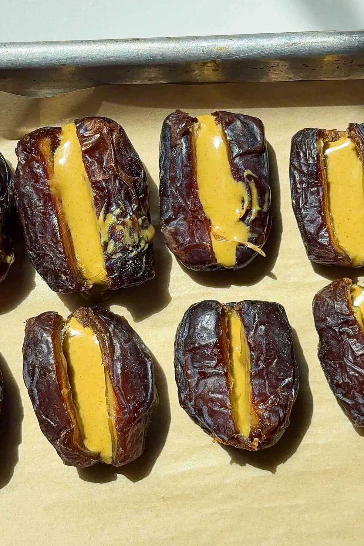 Filling dates with pistachio butter to make pistachio stuffed dates.