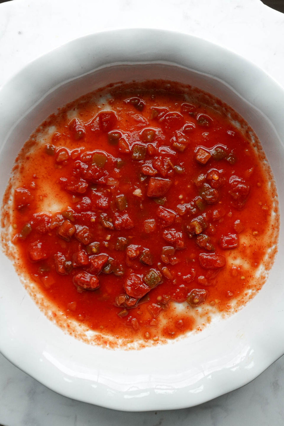 Salsa spread on the bottom of a casserole dish as the first layer
