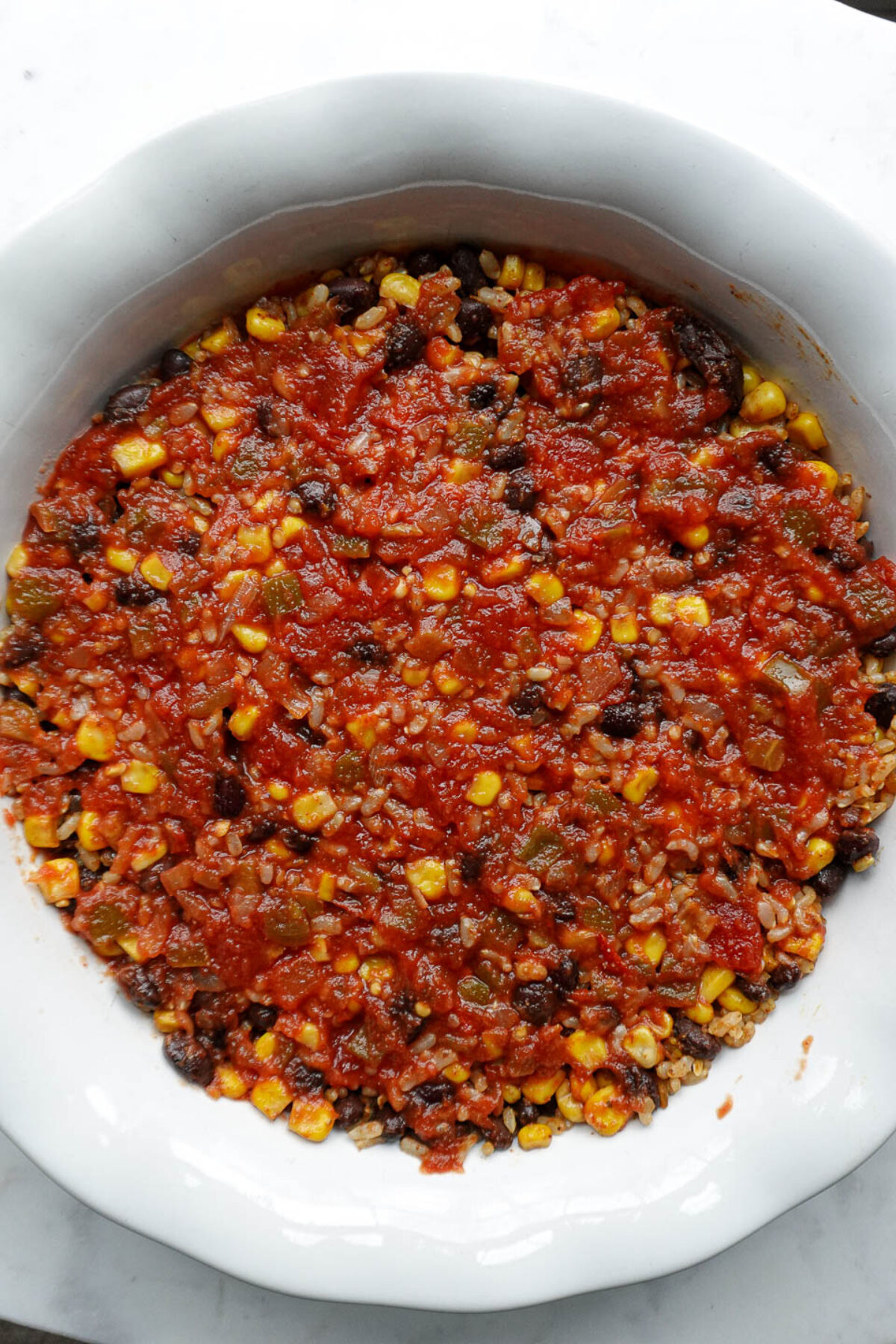 Second layer of salsa spooned over the rice and beans