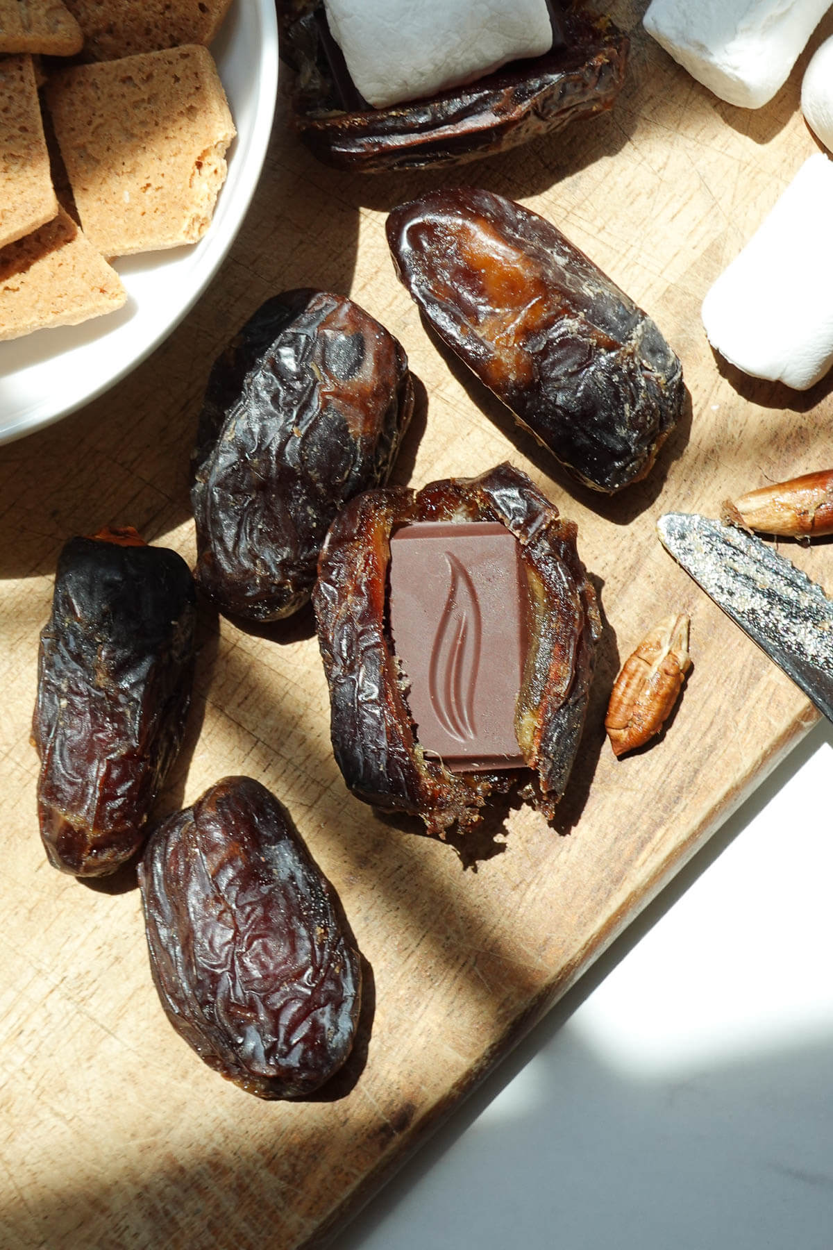 Medjool stuffed date cut open and filled with a piece of chocolate.