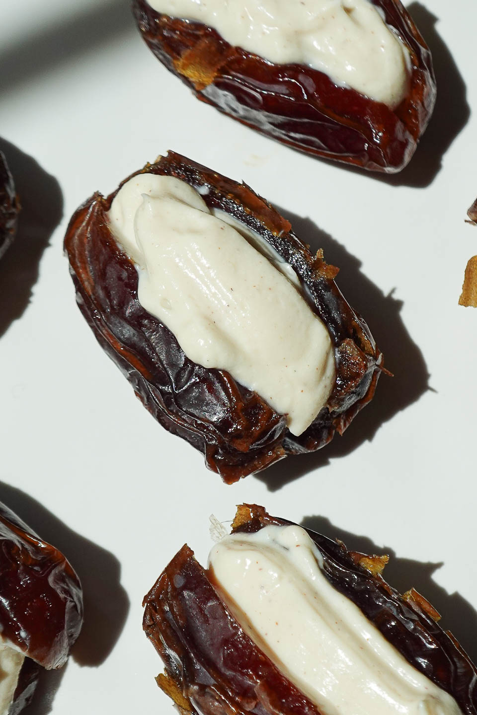 Filling a pitted Medjool date with vanilla yogurt for tiramisu stuffed dates.