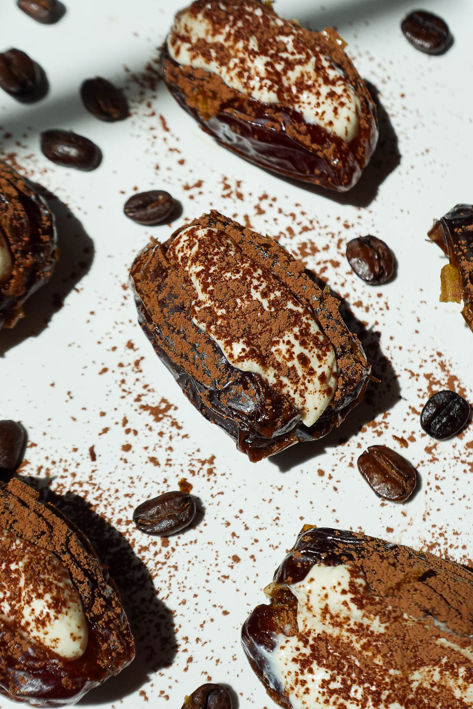 Medjool dates filled with vanilla yogurt and dusted with cocoa powder.