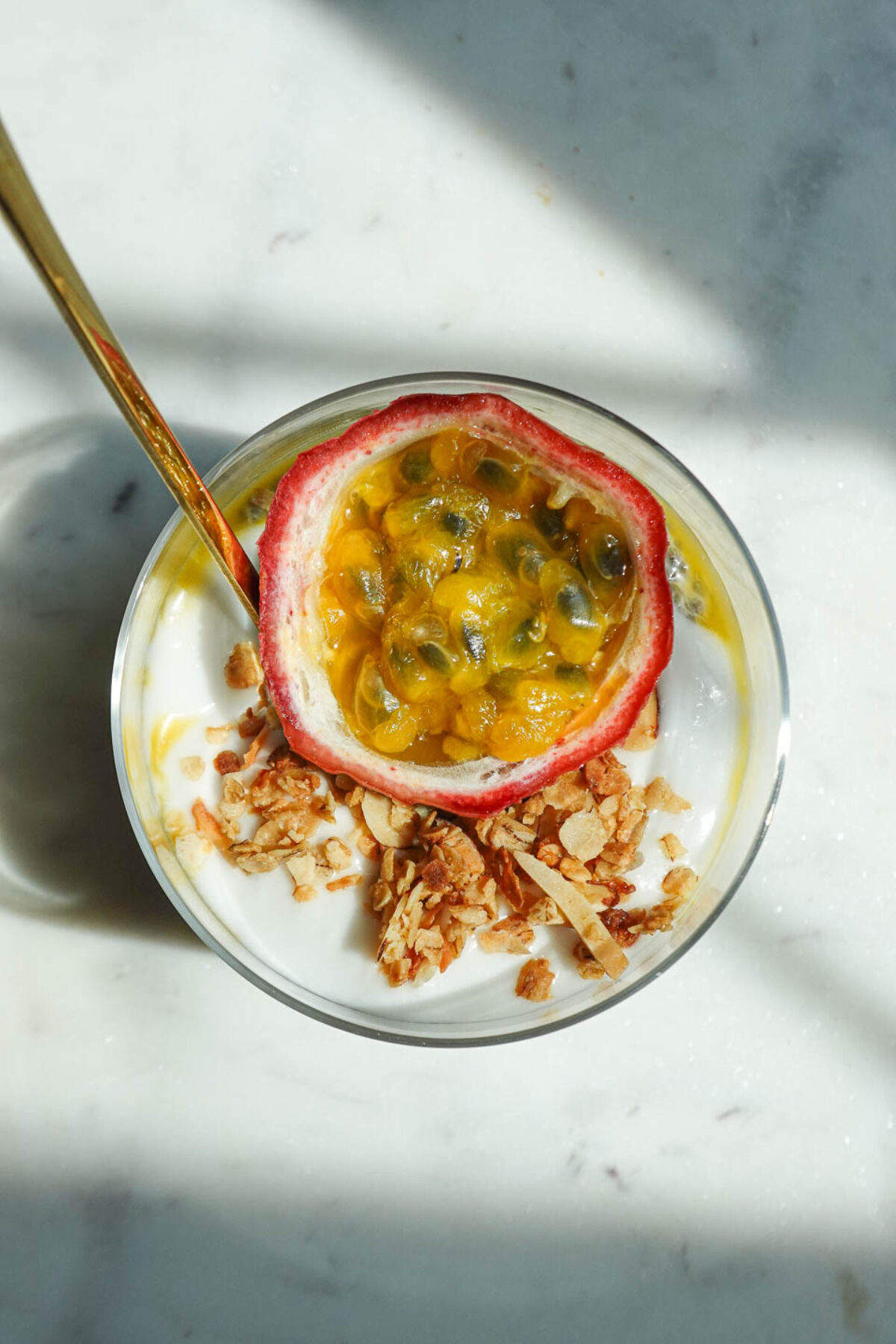 overhead shot of jar of passionfruit chia pudding with half a passionfruit on top
