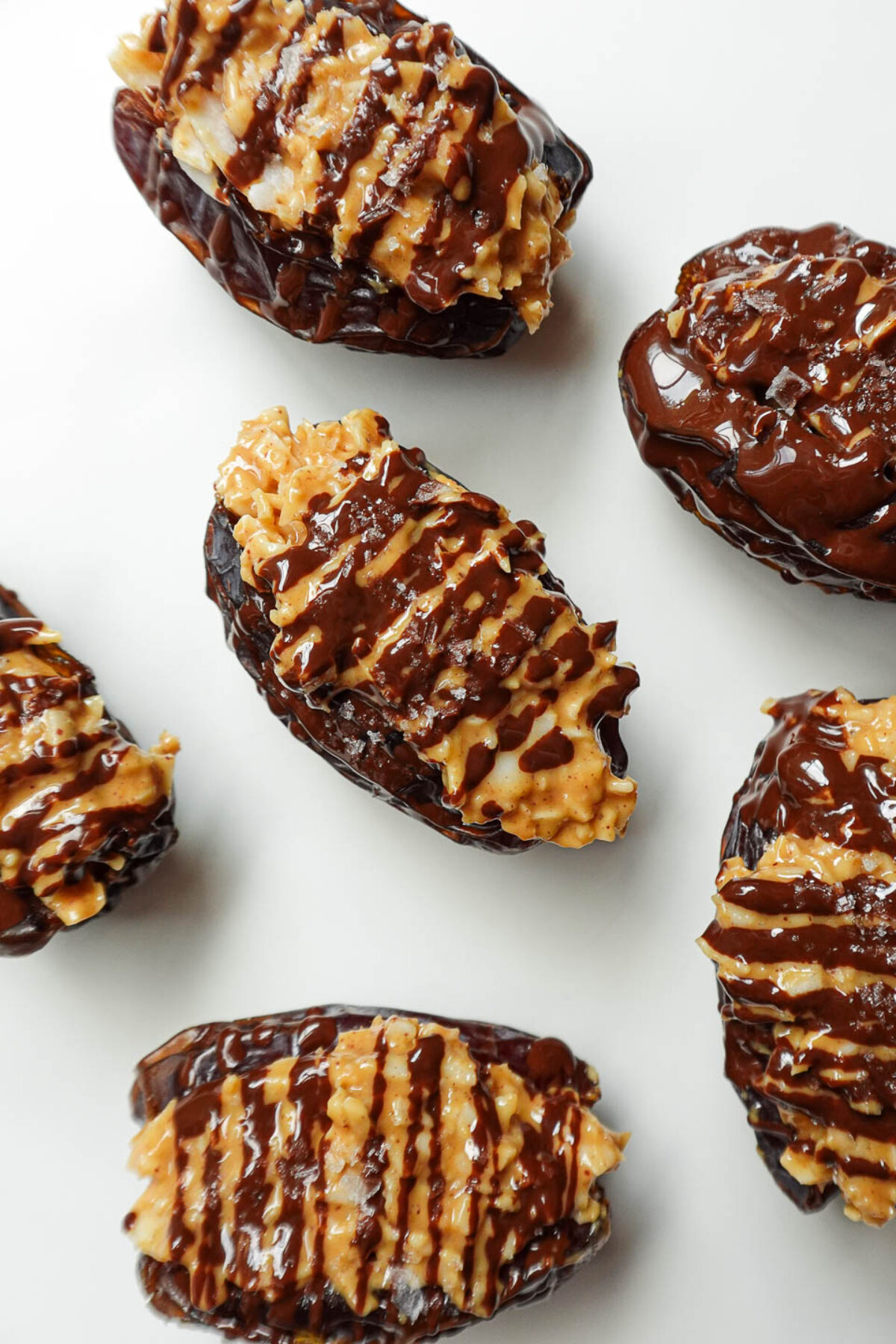 Vegan Samoas stuffed dates made with dates, chocolate, and coconut on a plate.