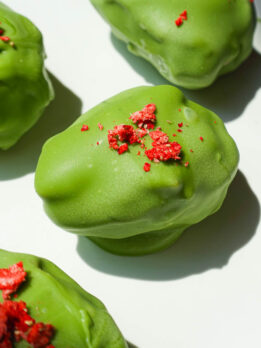 strawberry matcha stuffed date with creamy strawberry yogurt filling and green matcha coating