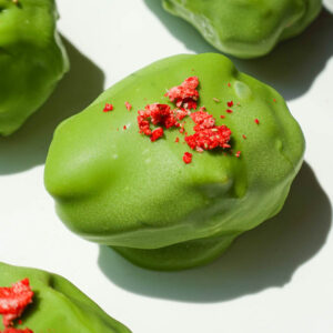 strawberry matcha stuffed date with creamy strawberry yogurt filling and green matcha coating