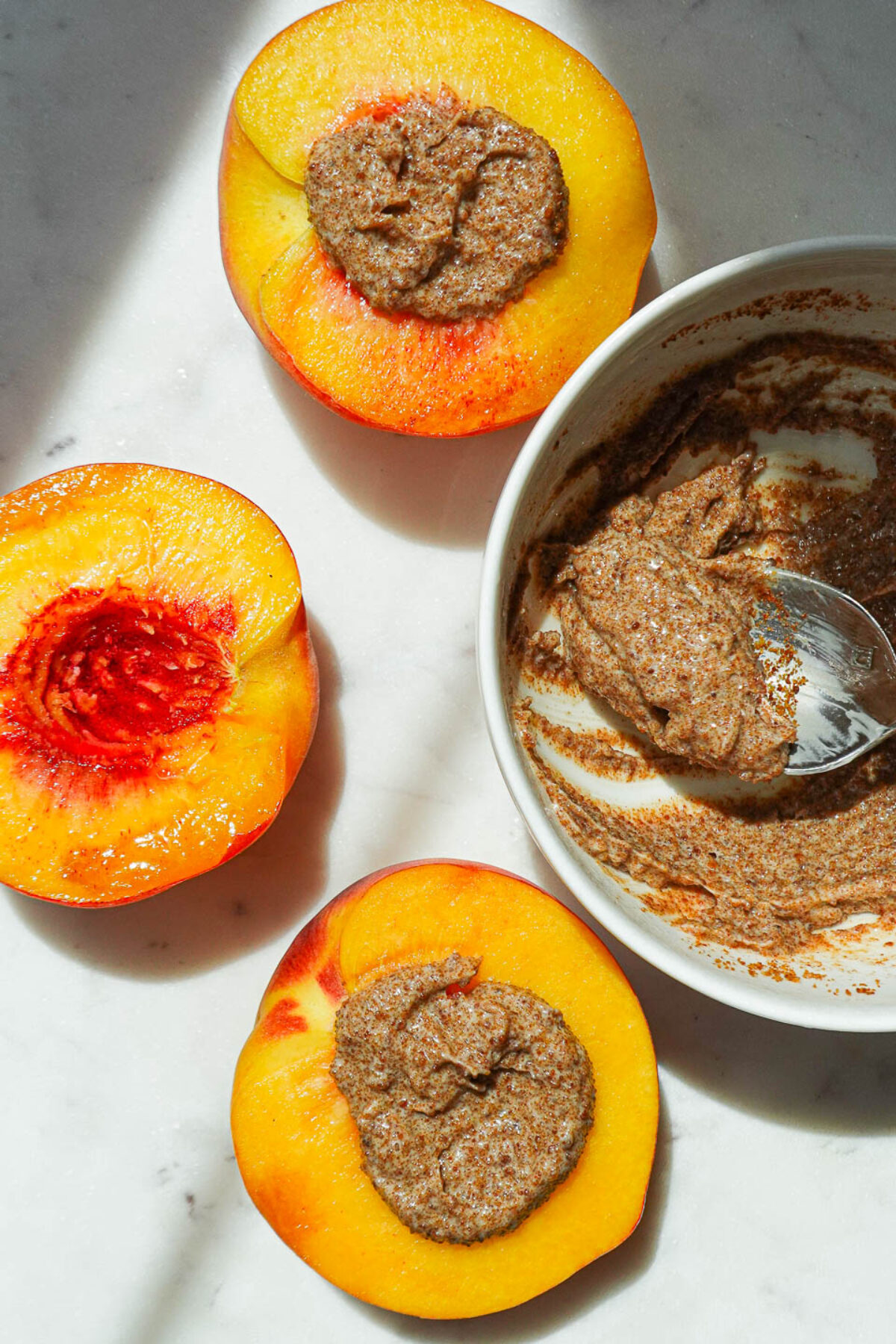 Adding cinnamon sugar butter topping to air fried peaches