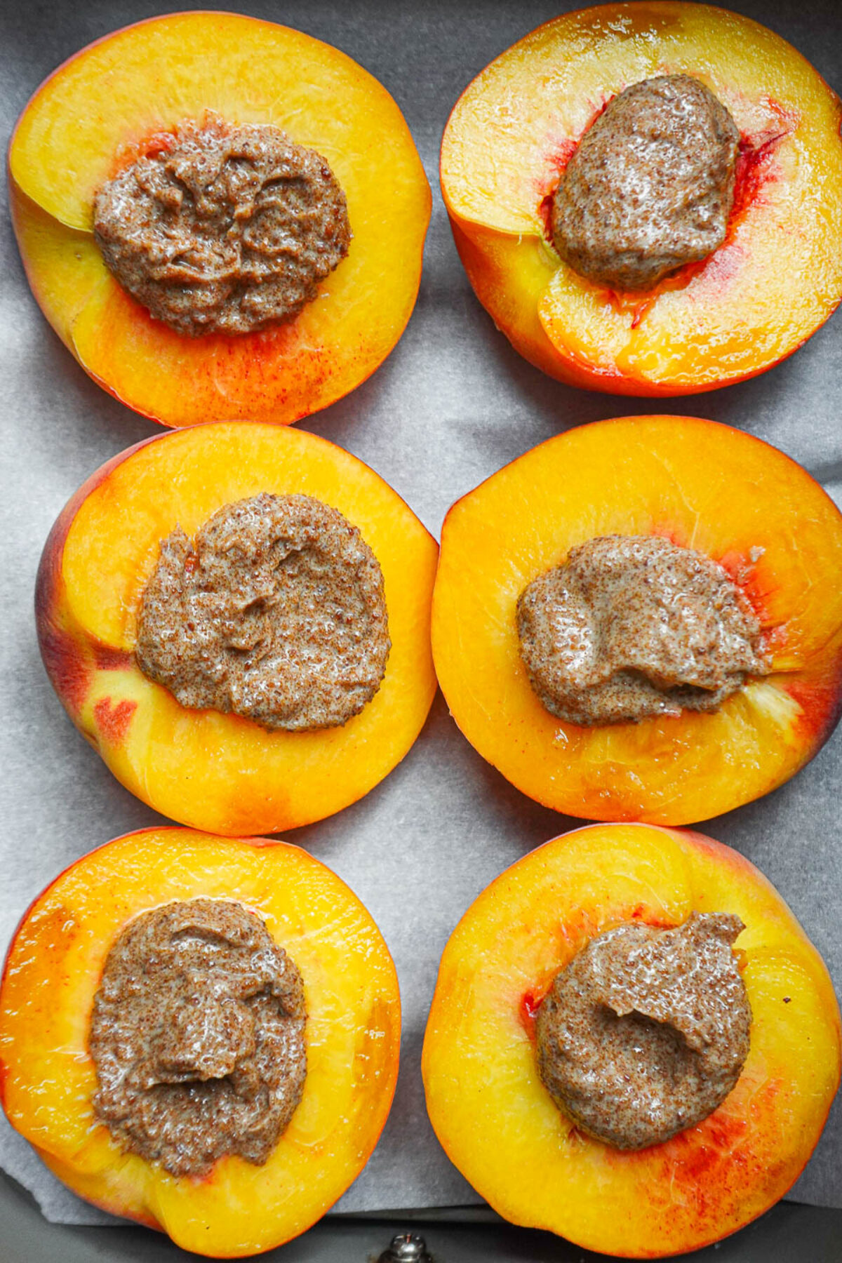 Fresh ripe peaches topped with cinnamon sugar butter ready for air frying