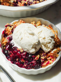 Healthy blueberry crisp served with vegan vanilla ice cream