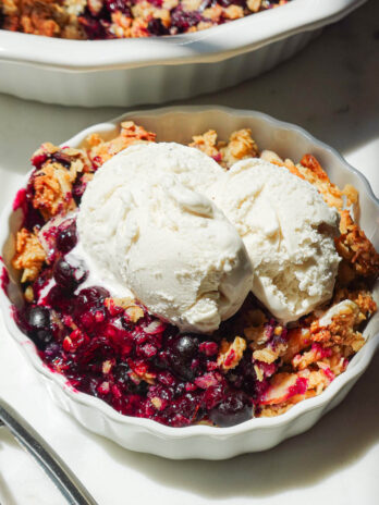 Healthy blueberry crisp served with vegan vanilla ice cream