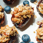 Air-fried Blueberry Crisp Stuffed Dates served with fresh blueberries on a white plate