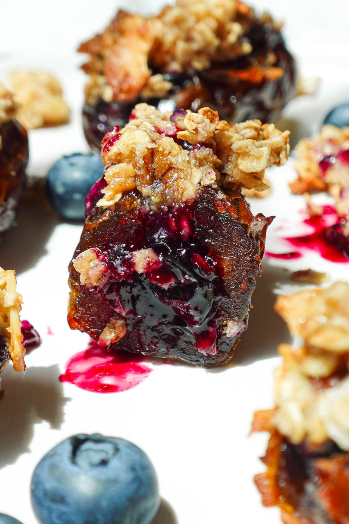 Blueberry Crisp Stuffed Date with a bite taken, revealing juicy blueberry compote inside