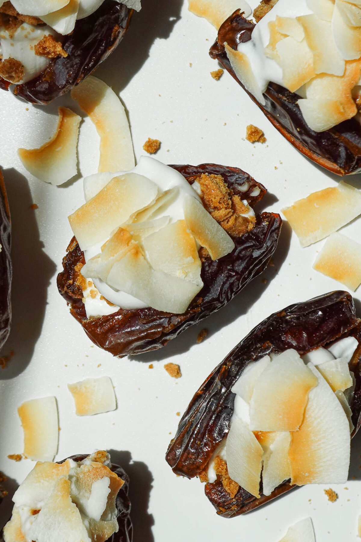 Overhead shot of coconut cream pie stuffed dates on a plate