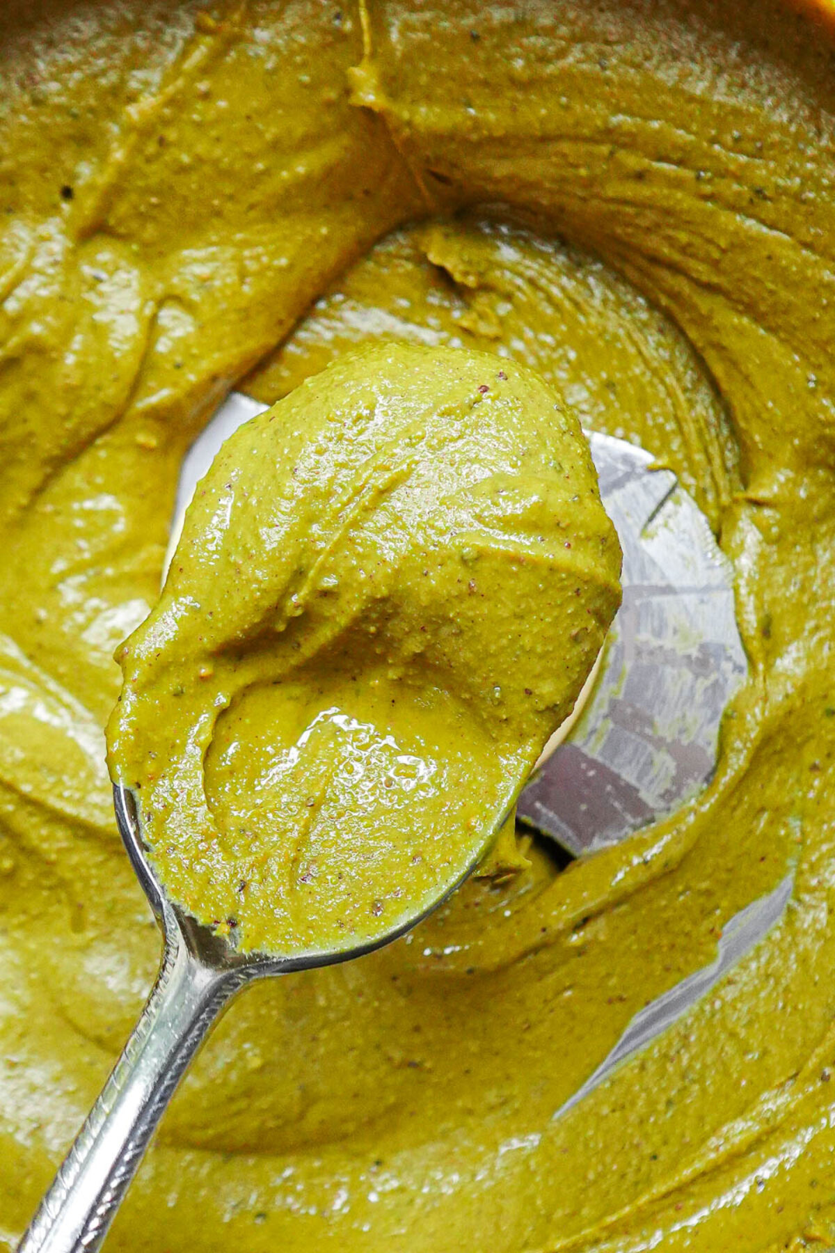 Close-up of smooth pistachio butter on a spoon