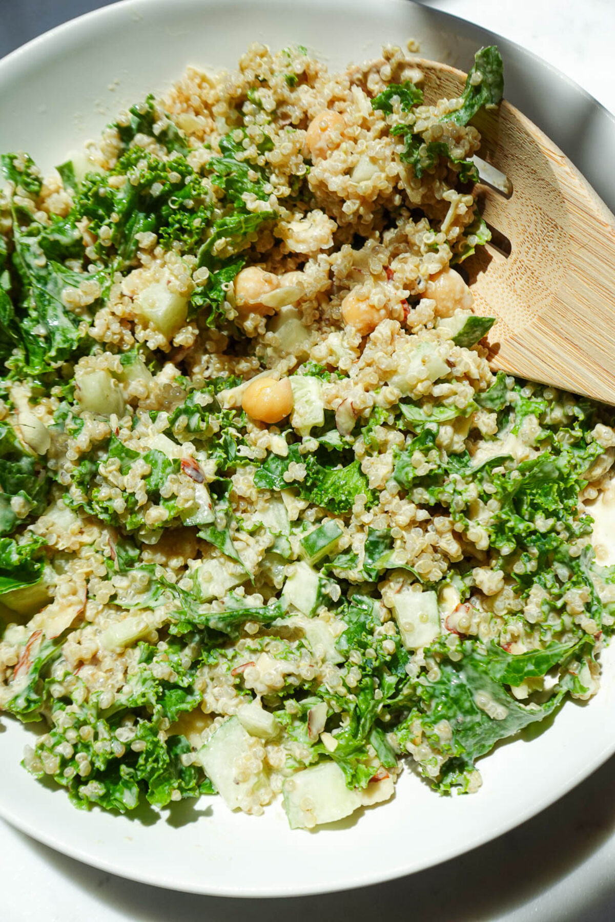 Healthy quinoa salad with chickpeas, kale, cucumber, and almonds