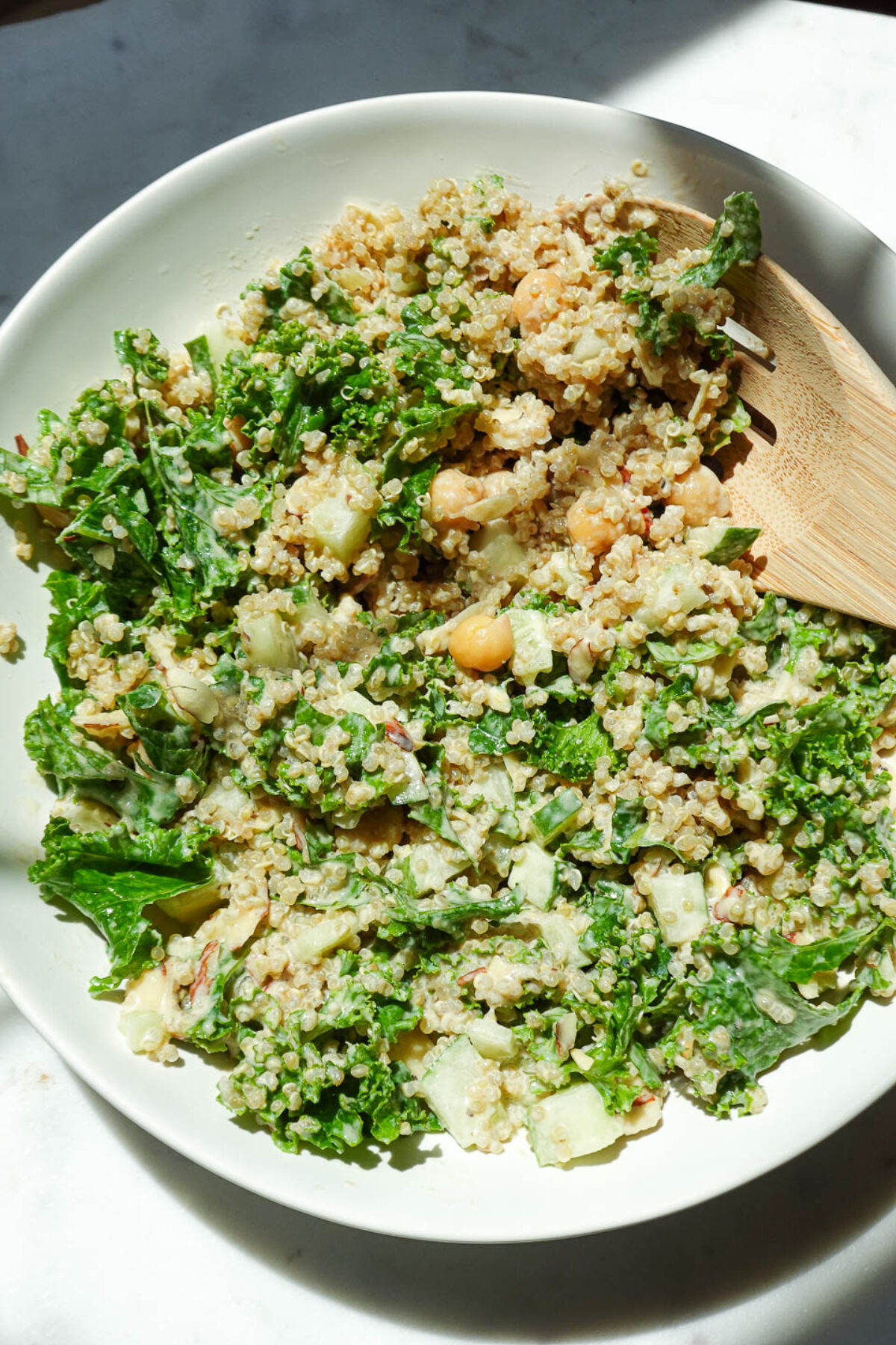 Flat lay of healthy vegan salad with kale, quinoa, and tahini dressing