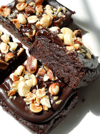 Close-up of rich and fudgy no bake brownies stacked to show ultra fudgy texture