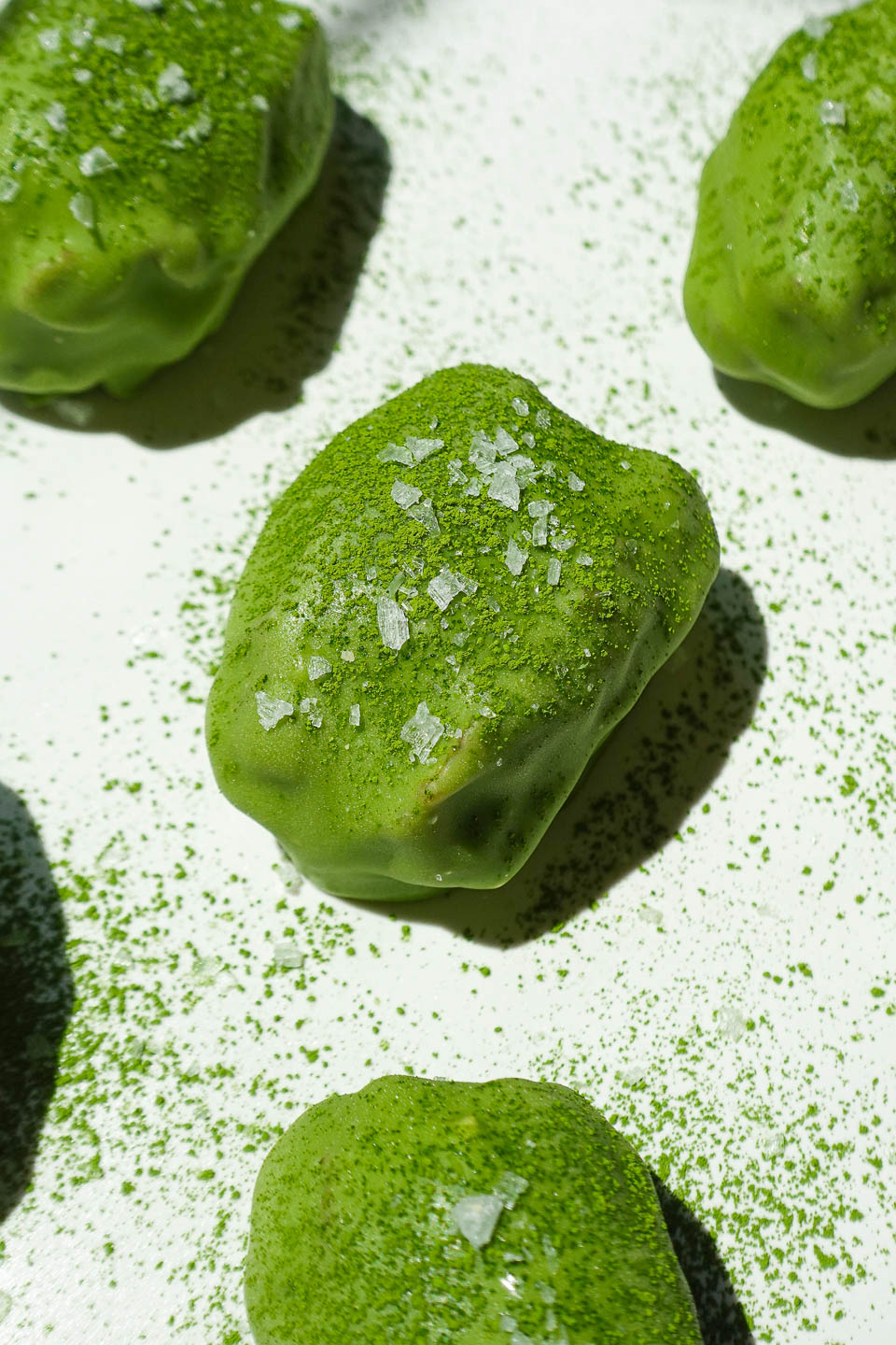 Healthy no-bake matcha dessert made with medjool dates, yogurt, and white chocolate matcha coating