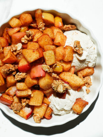 Easy air fryer apples with maple syrup, cinnamon, and granola in a serving bowl