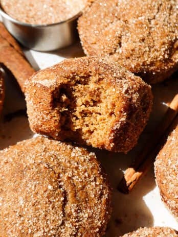 Close up of bite taken out of a soft, fluffy apple cider muffin