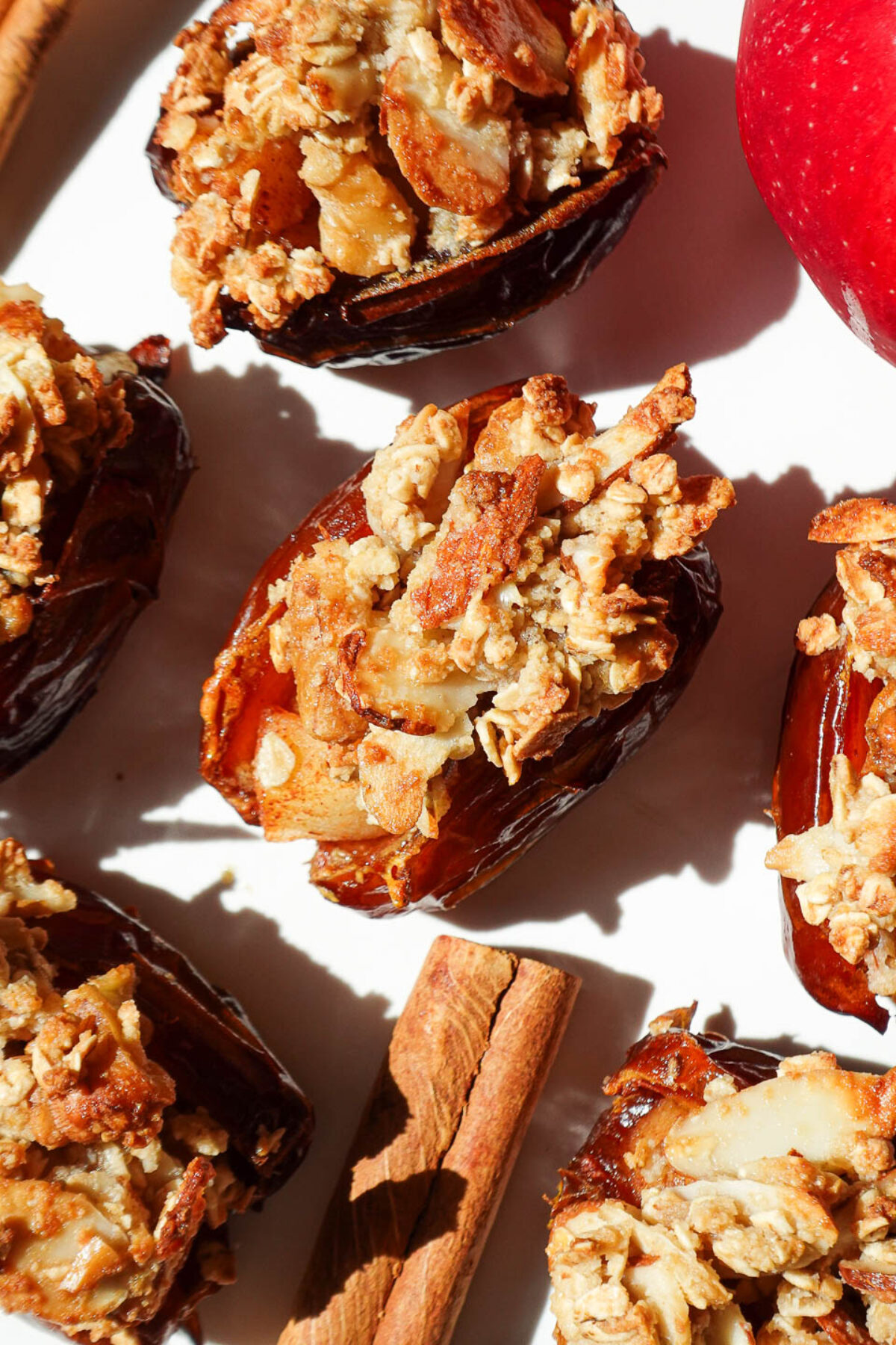 Apple crisp stuffed dates on a plate topped with oat crumble and golden from the air fryer