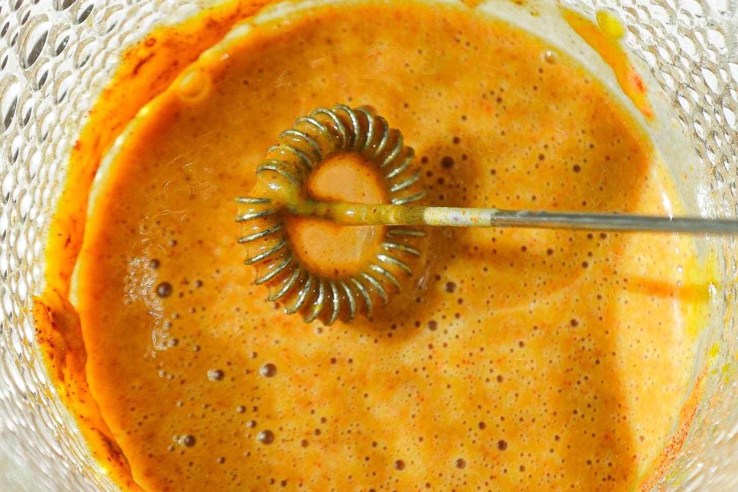 Frothing pumpkin milk with oat milk, pumpkin puree, maple syrup, and pumpkin pie spice