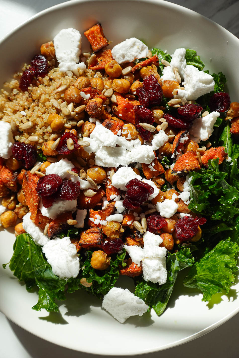 kale quinoa salad drizzled with creamy maple tahini dressing