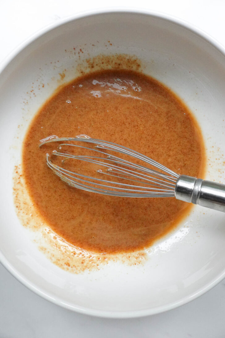 Mixing the wet ingredients to make peanut butter granola.
